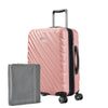 Rose gold Ricardo Mojave carry-on hardside suitcase with textured diagonal grooves shown with a large grey packing cube