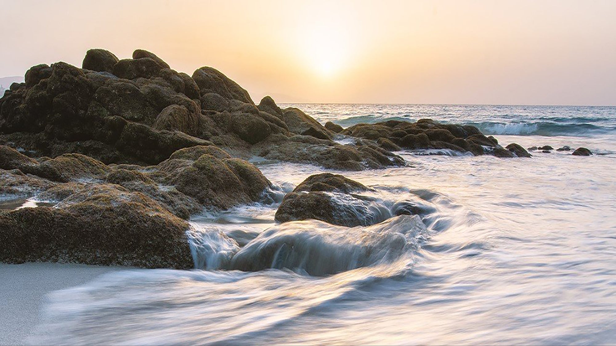 Rocks and ocean view at sunset