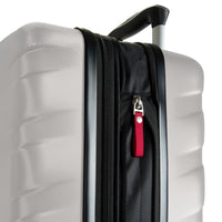 Close-up of a hard-shell suitcase in light gray with a black telescoping handle, black zipper track, and a red zipper pull tab on a white background.