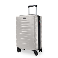 A Samsonite hard-shell spinner suitcase in a light champagne beige color, featuring a wavy ribbed design, an extended telescopic handle, and four multi-directional wheels.