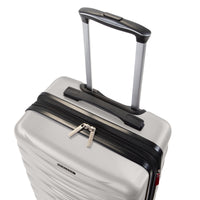 A close-up studio shot of a hard-shell spinner suitcase in light gray with black trim, an extended telescoping handle, and a top zipper with silver pulls on a white background.