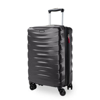 A dark gray hardside spinner suitcase with a textured wavy front panel, telescoping handle extended, and four wheels, shown on a white background.