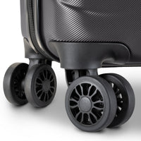 Close-up of a hard-shell suitcase in dark gray with dual spinner wheels, showing the textured shell and wheel details against a clean white background.