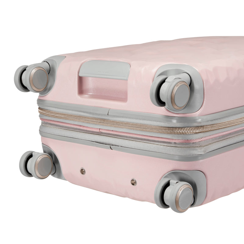 close up of grey wheels on blush pink rolling carry-on