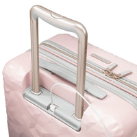 close up of USB charging port on blush pink carry-on suitcase