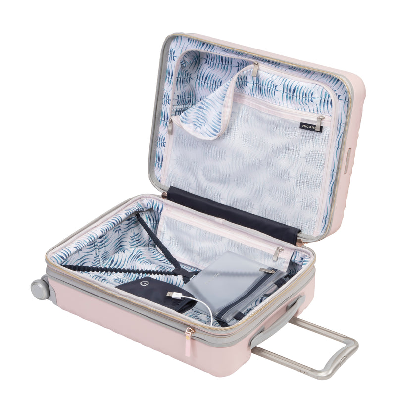 open blush pink carry-on suitcase with a blue and white patterned lining