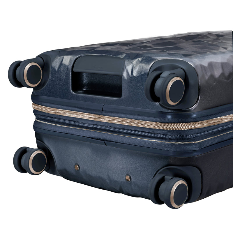 close up of wheels on navy blue rolling carry-on
