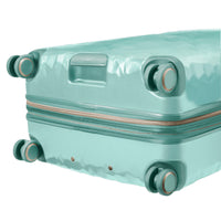close up of  wheels on mint rolling check in luggage