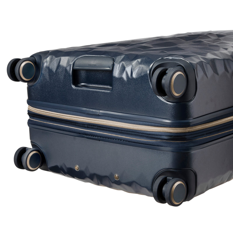 close up of  wheels on navy rolling check in luggage