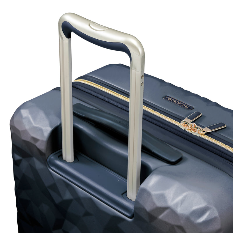 close up of ergonomic handle on Indio navy check in suitcase