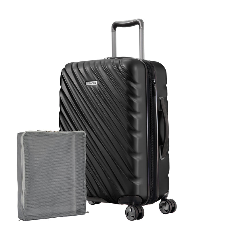 black Ricardo Mojave carry-on hardside suitcase with textured diagonal grooves shown with a large grey packing cube
