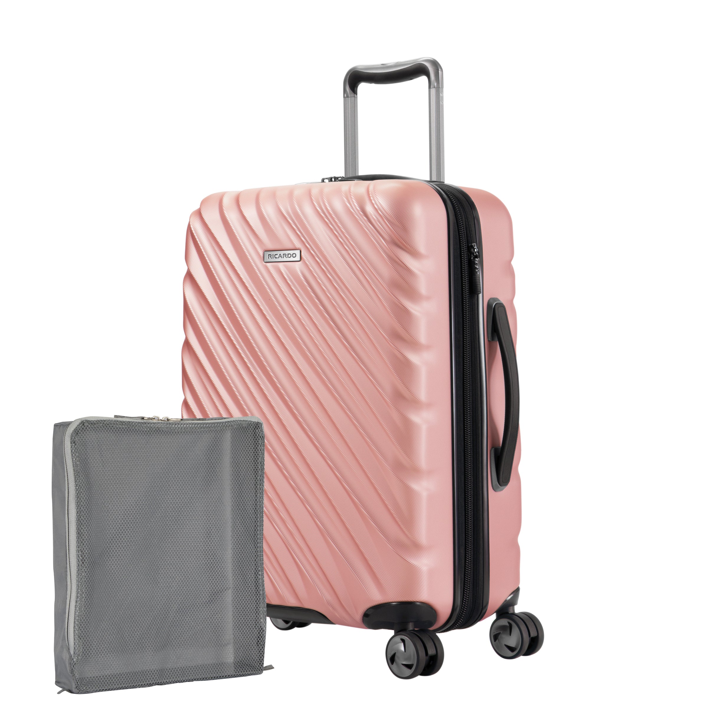 Rose gold Ricardo Mojave carry-on hardside suitcase with textured diagonal grooves shown with a large grey packing cube