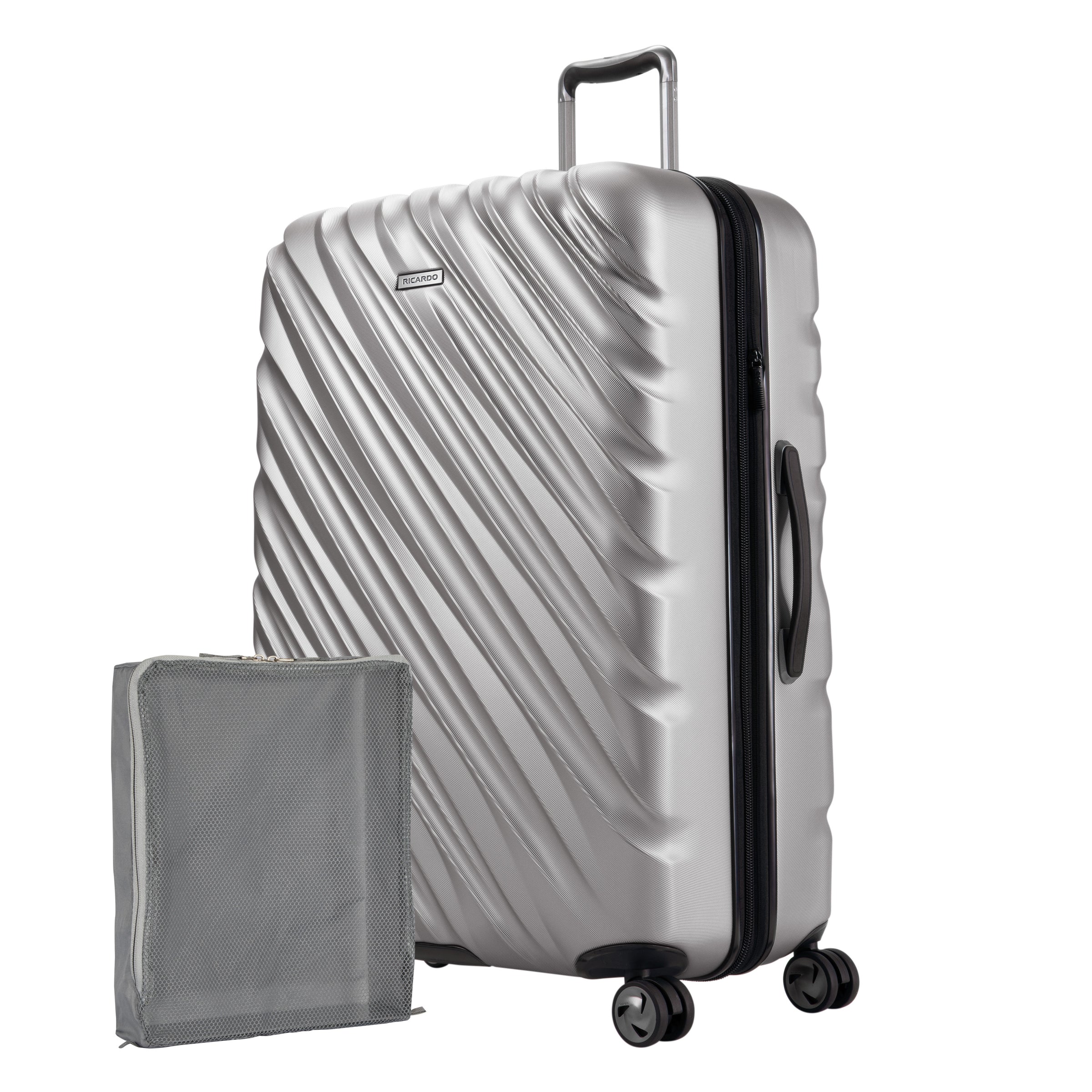 Platinum silver Ricardo Mojave carry-on hardside suitcase with diagonal grooves shown with a large grey packing cube