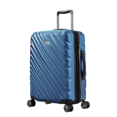 twilight blue Ricardo Mojave carry-on hardside suitcase with diagonal grooves and black accents on the wheels, zipper, and handles