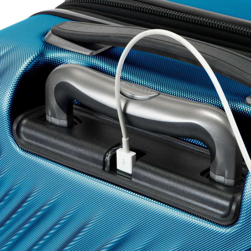 close up of USB charging port on twilight blue Mojave carry-on suitcase